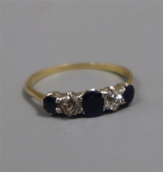 An 18ct, graduated sapphire and diamond five stone half hoop ring, size P.